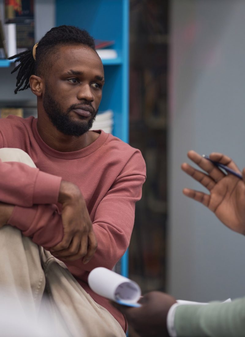 Black student listening to mental health therapist